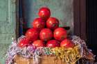 Still-life of a pyramid stack of pomegranates in a market. Art Print